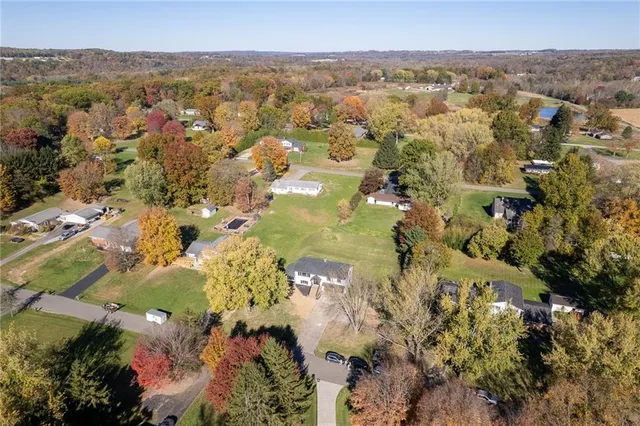 an aerial view of a residential houses with outdoor space