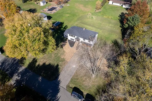 an aerial view of a houses with a yard