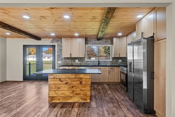 a kitchen with granite countertop stainless steel appliances and wooden cabinets