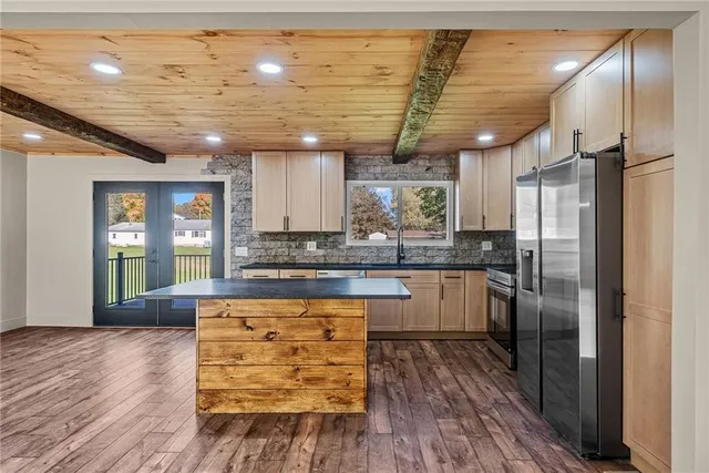 a kitchen with granite countertop stainless steel appliances and wooden cabinets