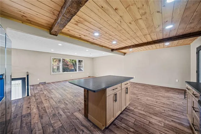 a kitchen with a stove and wooden floor