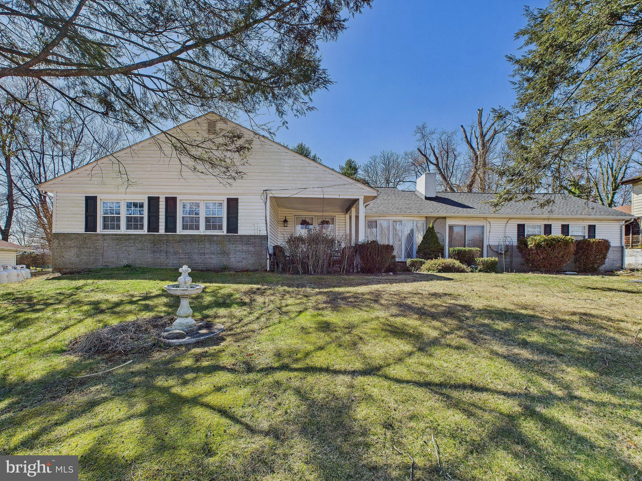8005 Windsor Mill Road Baltimore, MD 21244 - Photo 1 of 39 a front view of a house with a yard