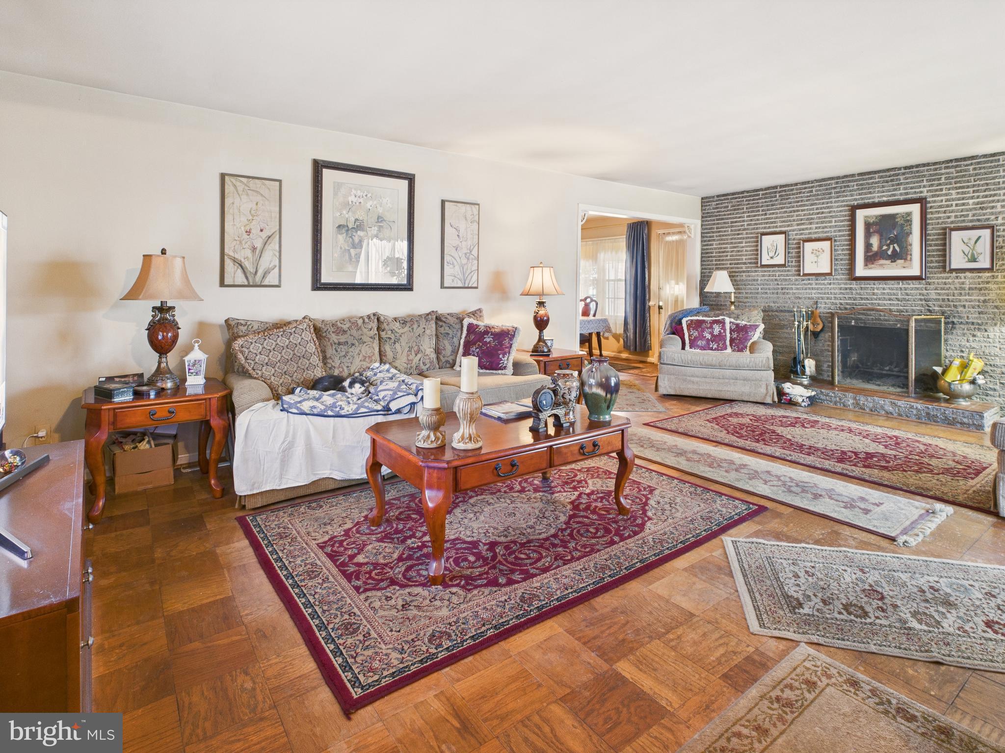 8005 Windsor Mill Road Baltimore, MD 21244 - Photo 12 of 39 a living room with furniture a rug and a fireplace