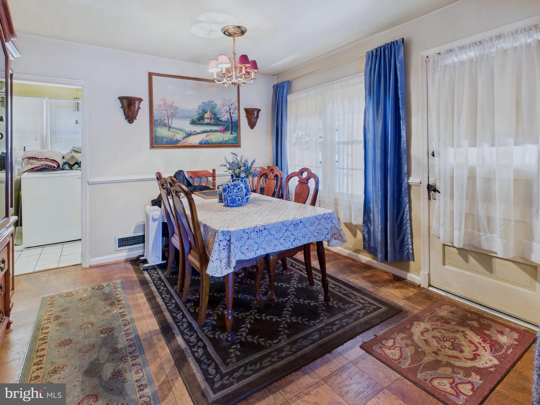 8005 Windsor Mill Road Baltimore, MD 21244 - Photo 14 of 39 a view of a dining room with furniture window and wooden floor