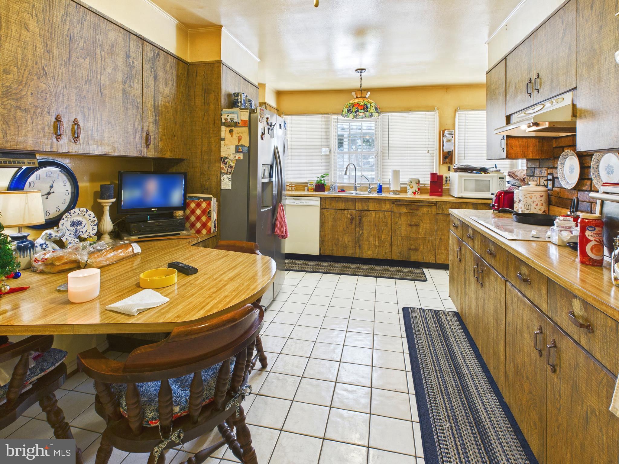 8005 Windsor Mill Road Baltimore, MD 21244 - Photo 19 of 39 a kitchen with stainless steel appliances a sink a stove and a refrigerator
