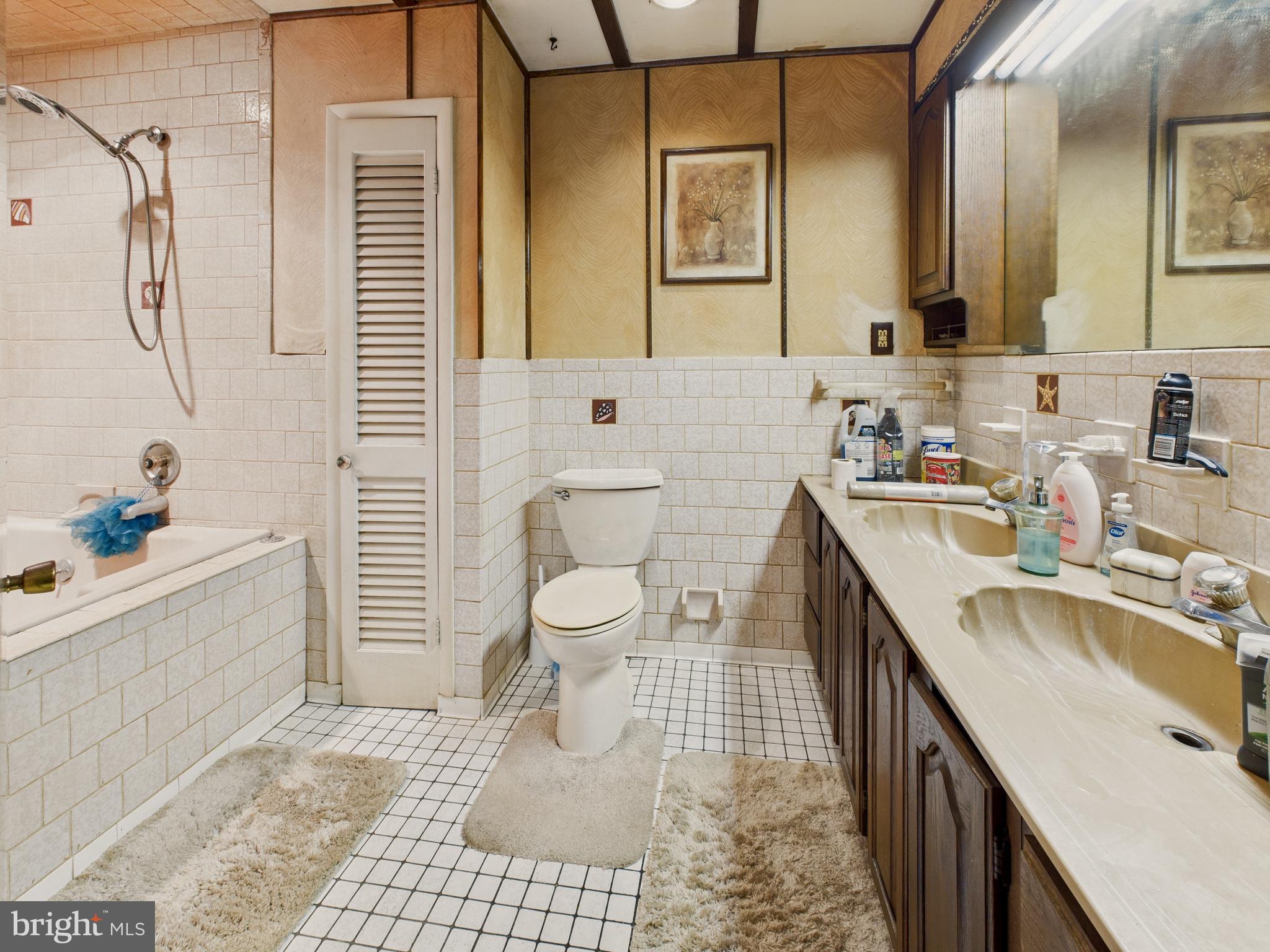 8005 Windsor Mill Road Baltimore, MD 21244 - Photo 23 of 39 a bathroom with a sink a toilet and shower