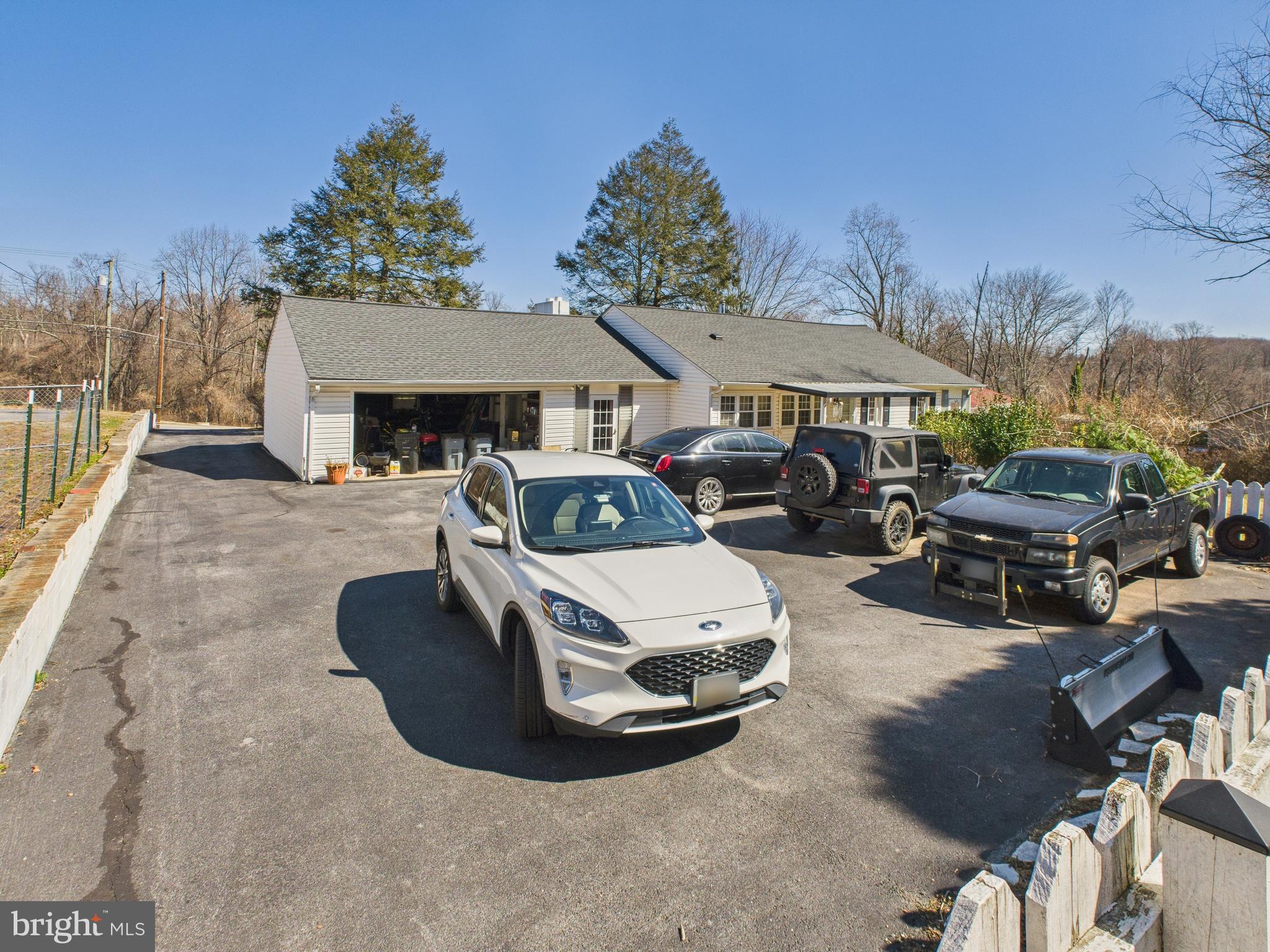 8005 Windsor Mill Road Baltimore, MD 21244 - Photo 29 of 39 a roof deck with table and chairs a fire pit and two lawn chairs