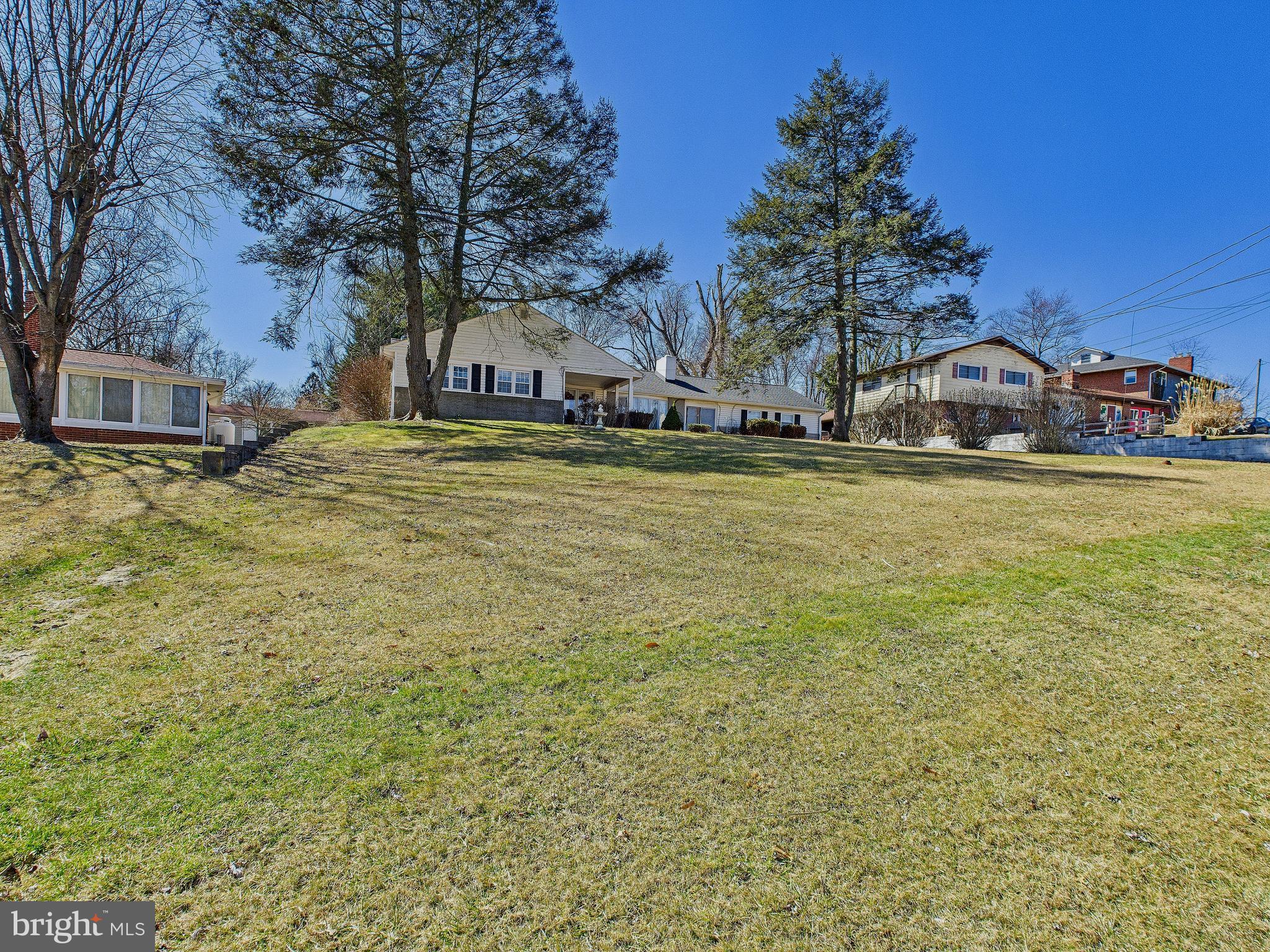 8005 Windsor Mill Road Baltimore, MD 21244 - Photo 3 of 39 a front view of a house with a yard and a garage