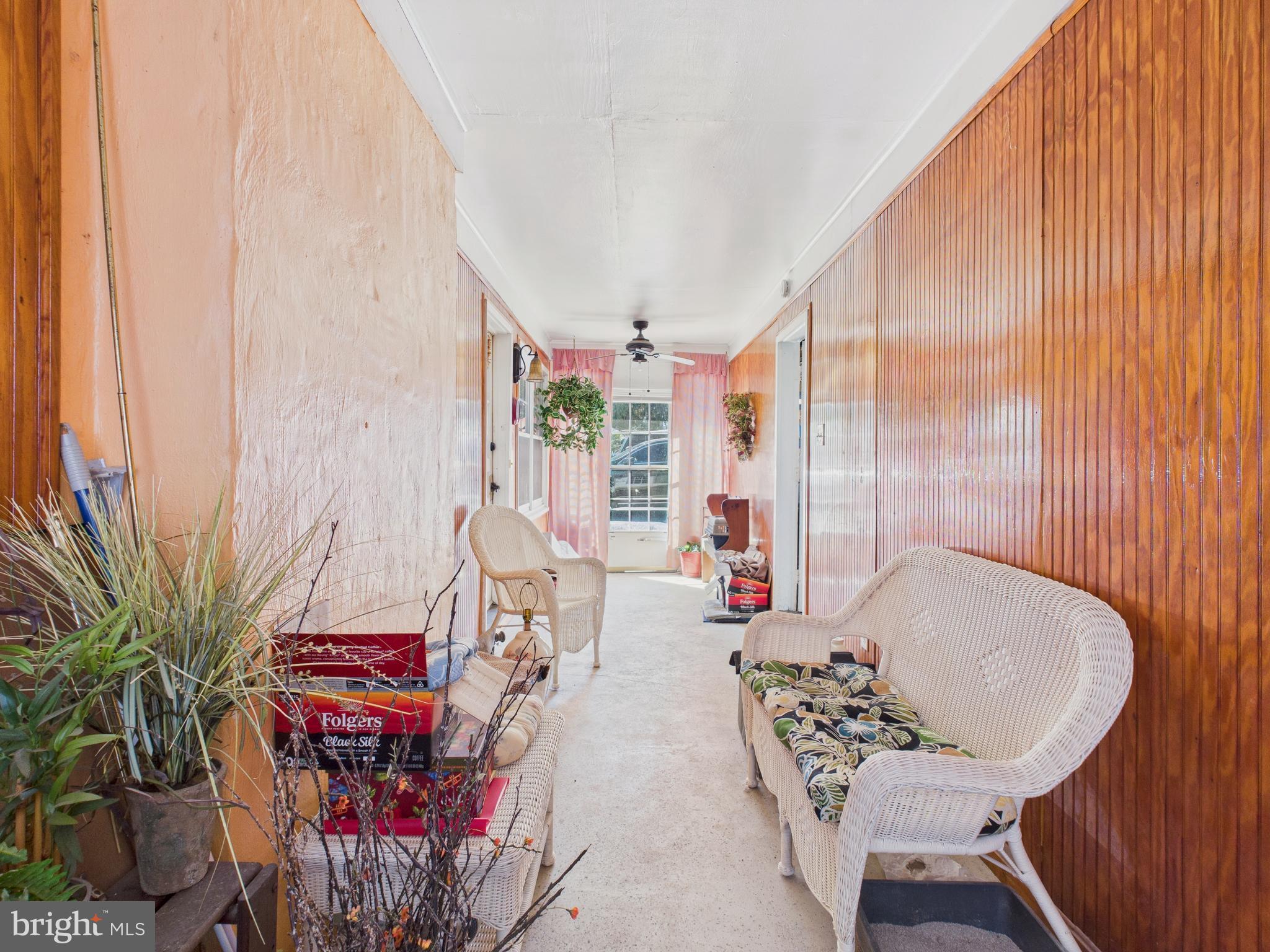 8005 Windsor Mill Road Baltimore, MD 21244 - Photo 9 of 39 a living room with furniture and a potted plant