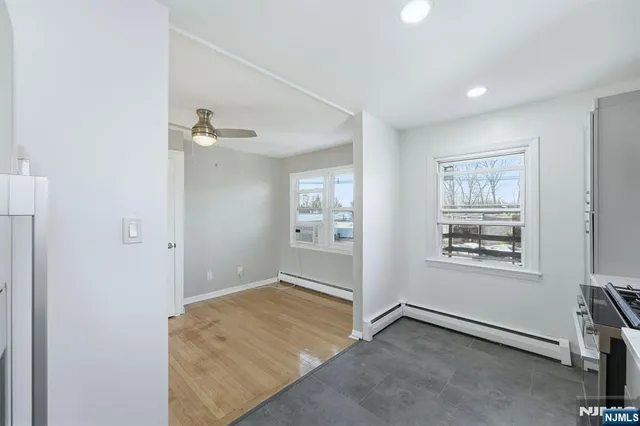 an empty room with windows and closet