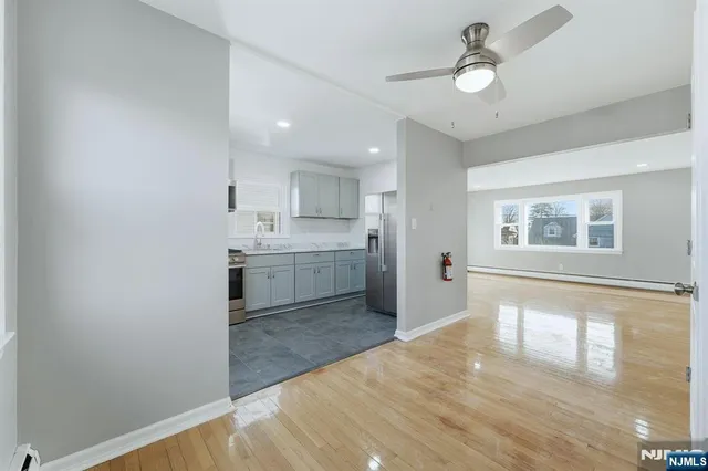 a view of a kitchen with wooden floor and a sink