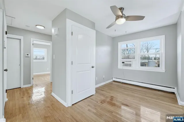 a view of livingroom with hardwood floor and ceiling fan