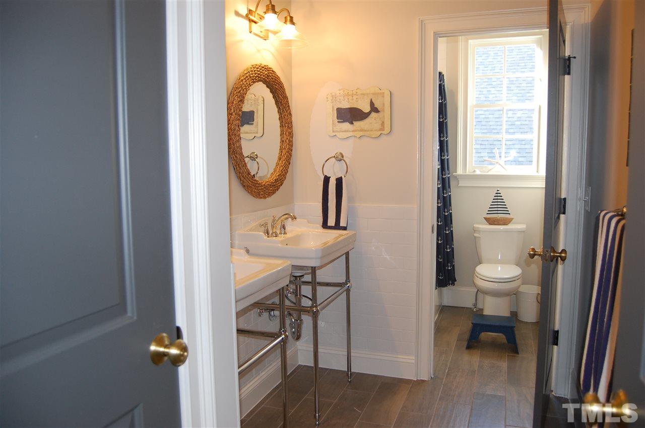 2620 Davis Street Raleigh, NC 27608 - Photo 24 of 28 Bathroom with dual vanities and separate tub/shower area.