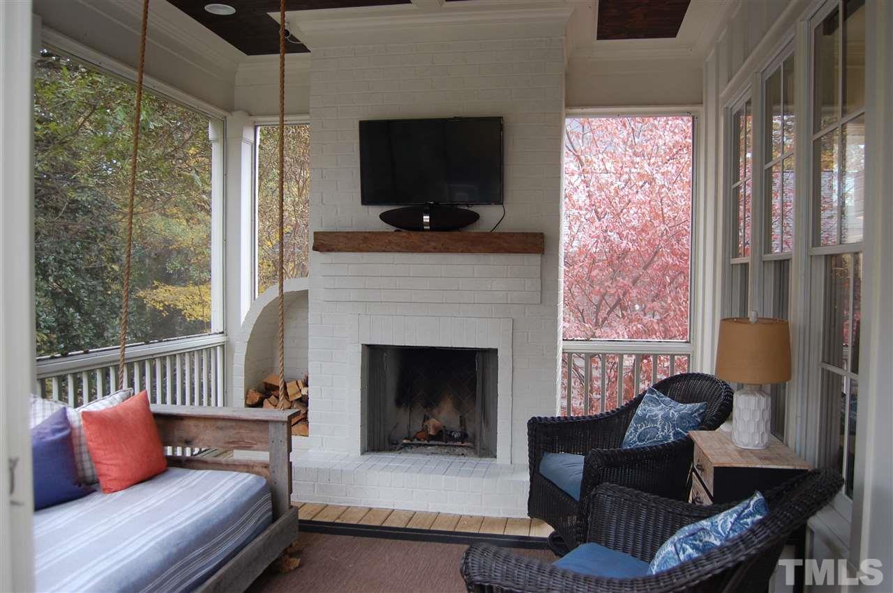 2620 Davis Street Raleigh, NC 27608 - Photo 27 of 28 Enjoy the beautiful magnolia trees and private backyard from this lovely screened porch.