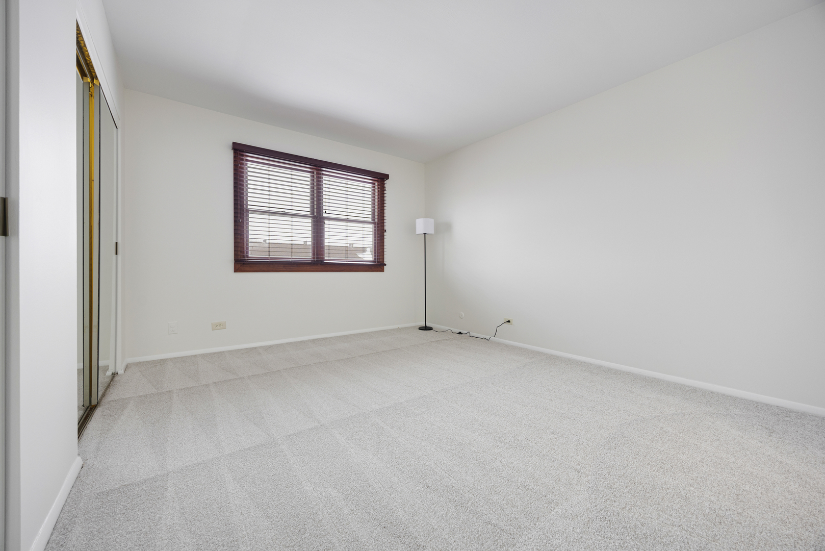 1724 Fayette Walk, Unit J Hoffman Estates, IL 60169 - Photo 11 of 15 an empty room with a window