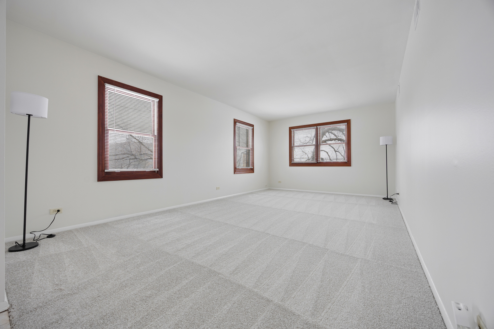 1724 Fayette Walk, Unit J Hoffman Estates, IL 60169 - Photo 4 of 15 a view of an empty room with windows