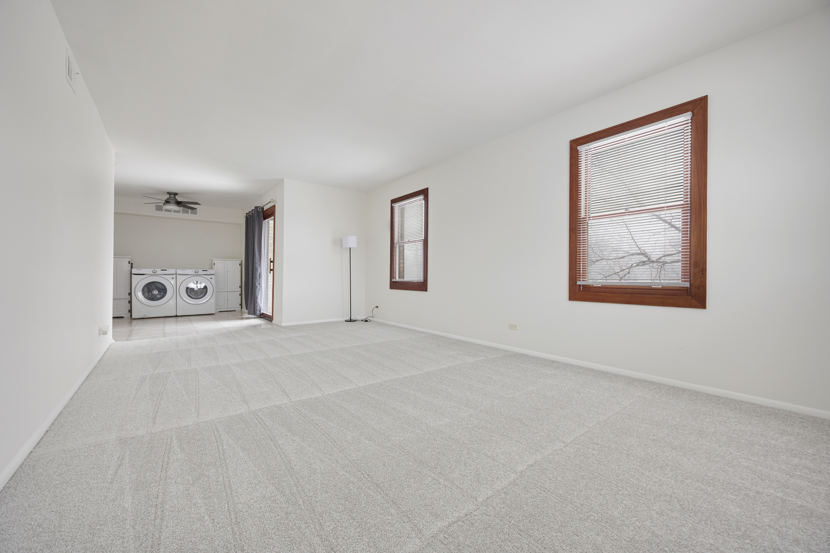 1724 Fayette Walk, Unit J Hoffman Estates, IL 60169 - Photo 5 of 15 an empty room with windows and mirror