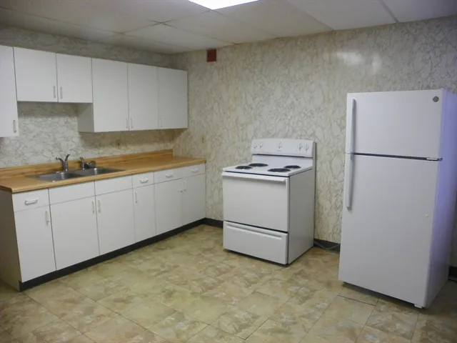 a utility room with sink dryer and washer