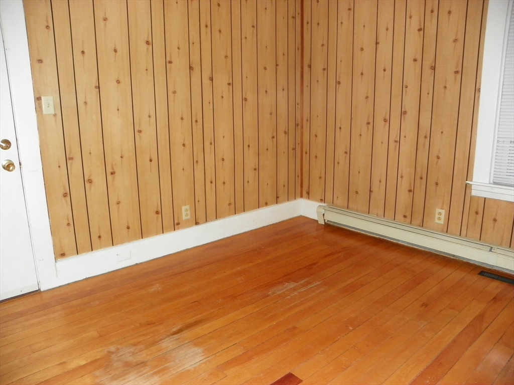 19 Franklin Court, Unit 1R Gardner, MA 01440 - Photo 5 of 8 a view of an empty room with wooden floor