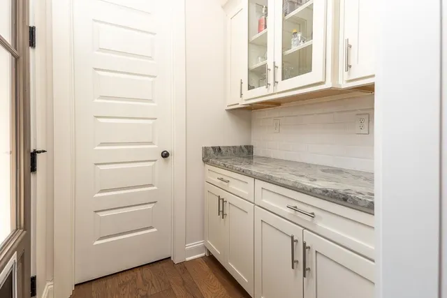 a large kitchen with a table and chairs