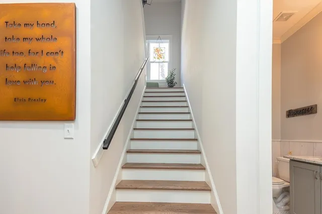 a view of a hallway with wooden floor and entryway