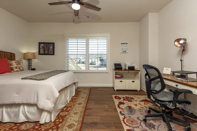 a bed room with a bed and a chair