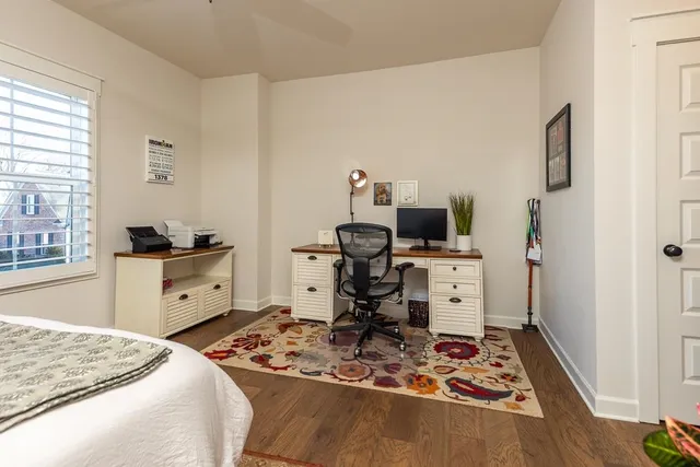a kitchen with a stove and a wooden floor