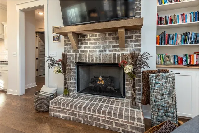 a kitchen with stainless steel appliances granite countertop a table chairs stove refrigerator and cabinets