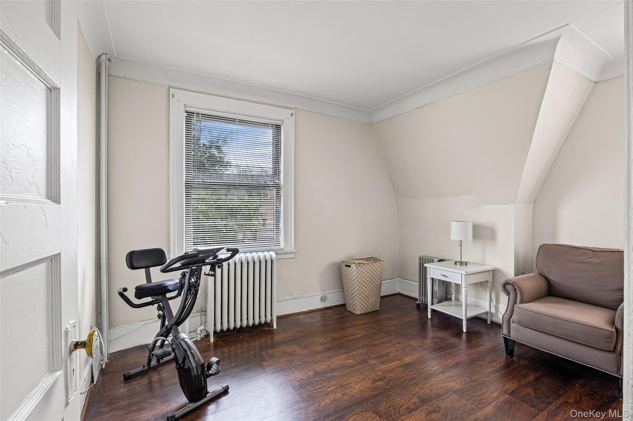 42-15 204th Street Queens, NY 11361 - Photo 12 of 23 a living room with furniture a window and a wooden floor