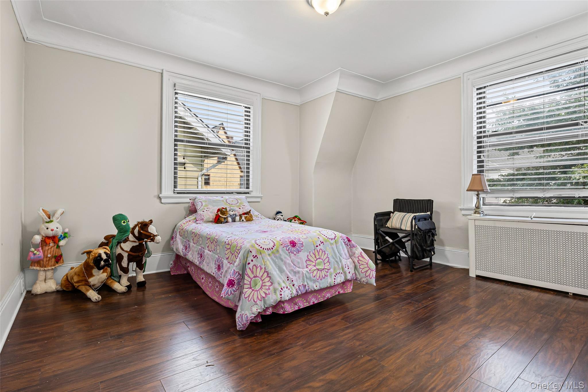 42-15 204th Street Queens, NY 11361 - Photo 13 of 23 a bedroom with a bed and wooden floor