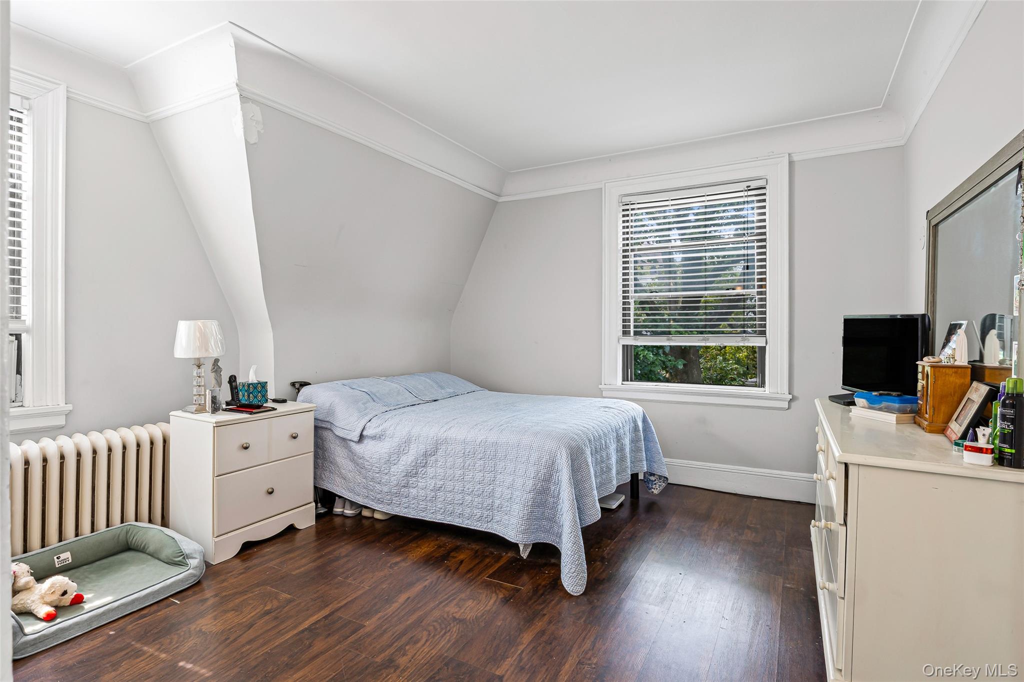 42-15 204th Street Queens, NY 11361 - Photo 14 of 23 a bedroom with a bed and a window