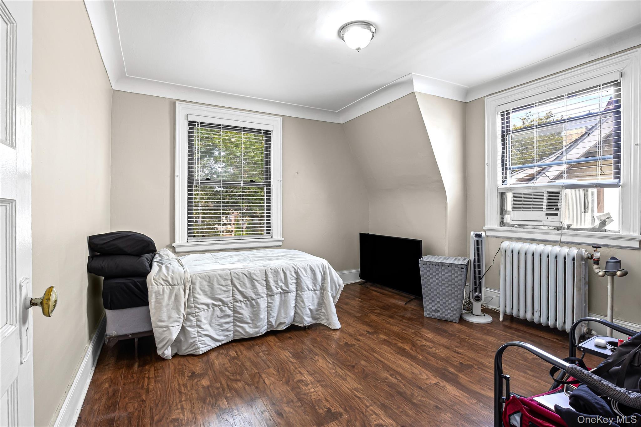42-15 204th Street Queens, NY 11361 - Photo 16 of 23 a bedroom with furniture and a window