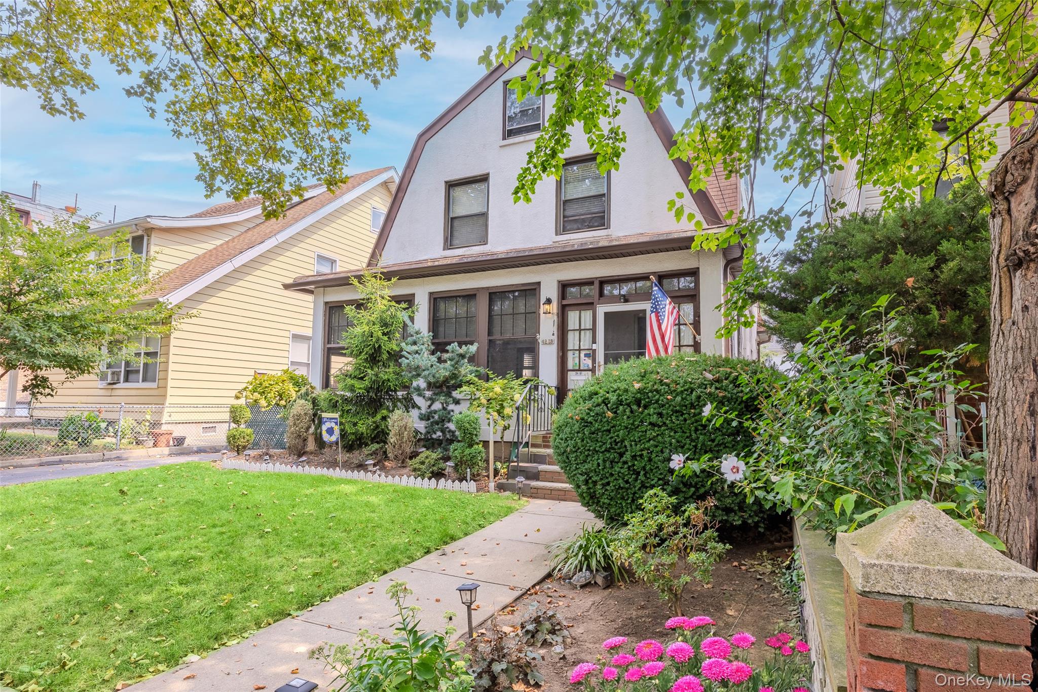 42-15 204th Street Queens, NY 11361 - Photo 2 of 23 a front view of a house with a yard