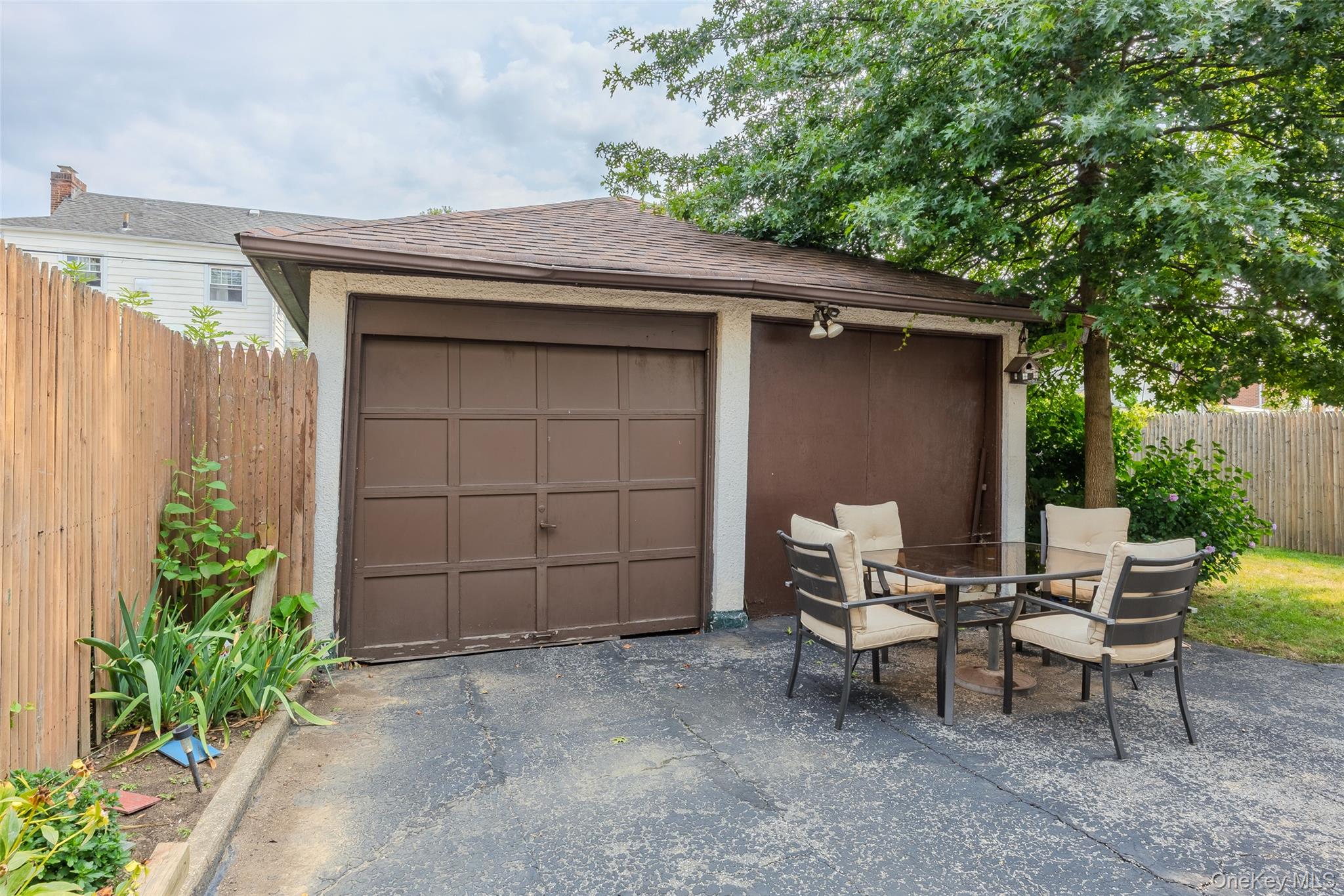 42-15 204th Street Queens, NY 11361 - Photo 21 of 23 a backyard of a house with yard and outdoor seating