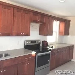 a kitchen with a cabinets and a stove top oven