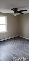 a view of a room with wooden floor and window