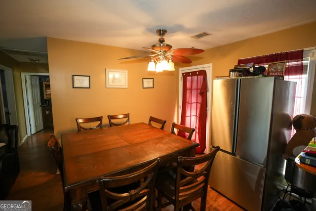 a view of a dining room with furniture and a chandelier