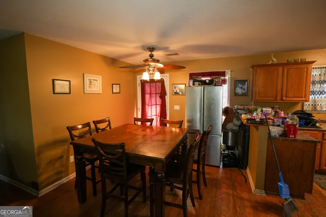 a view of a dining room with furniture and chandelier