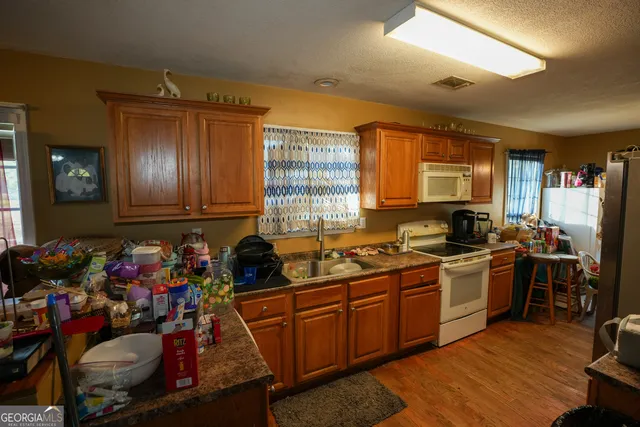 a kitchen with a sink stove and cabinets