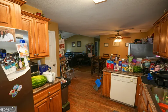 a view of a kitchen with dining table and chairs