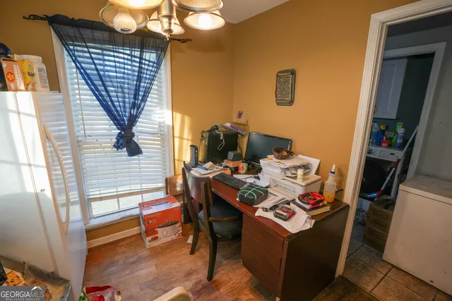 a view of a workspace with furniture and a window