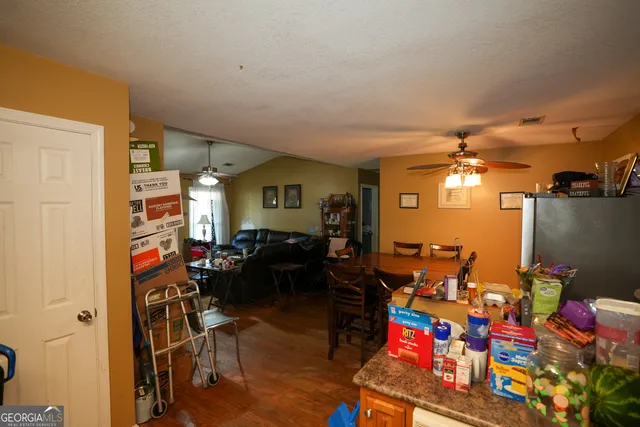 a living room with lots of furniture and a flat screen tv
