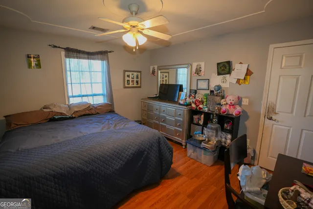 a bedroom with furniture and a window