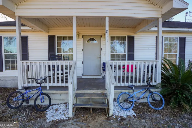 a view of a dinning room with wooden floor and furniture