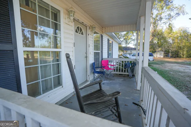 a view of a patio with a table chairs and a backyard