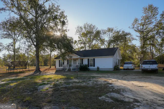 a view of a yard with a house and a tree