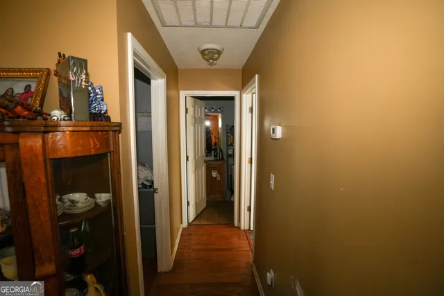 a view of a hallway with wooden shelves
