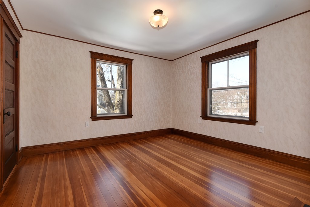 80 Spring Road Needham, MA 02494 - Photo 11 of 25 a view of an empty room with wooden floor and a window