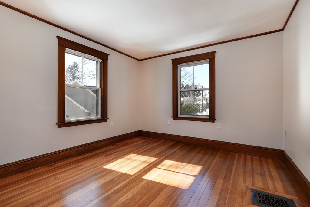 80 Spring Road Needham, MA 02494 - Photo 12 of 25 an empty room with wooden floor and windows