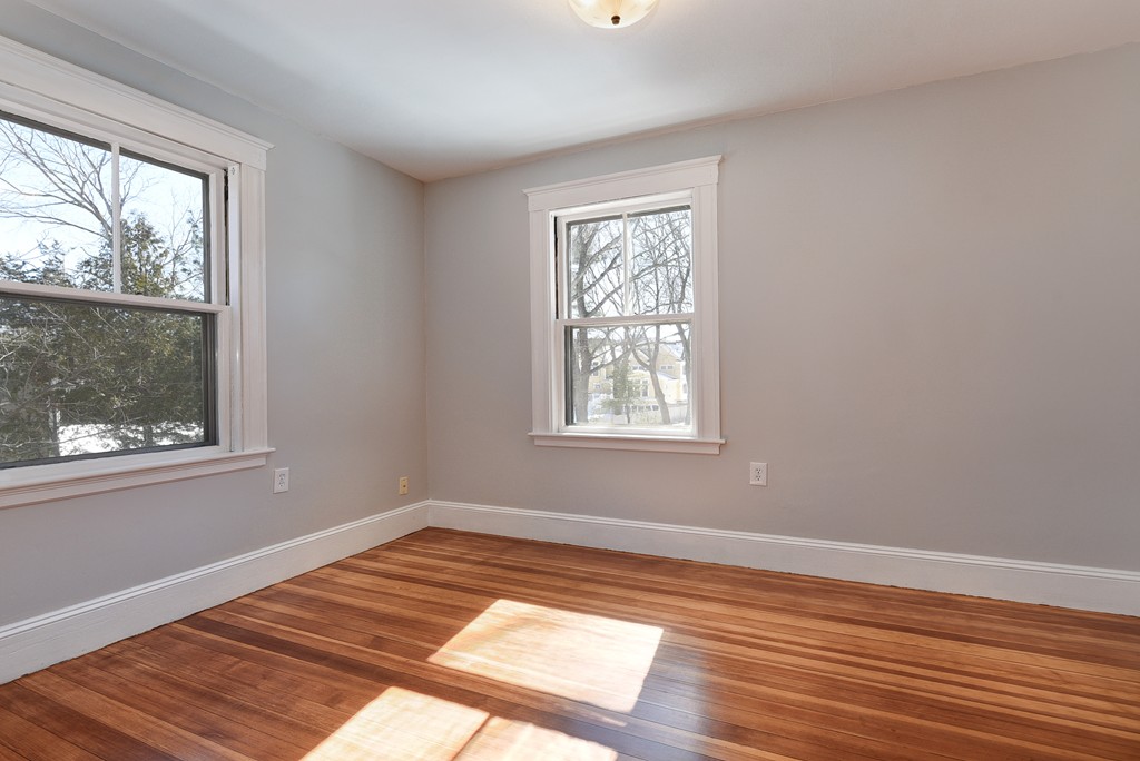 80 Spring Road Needham, MA 02494 - Photo 13 of 25 a view of an empty room with wooden floor and a window